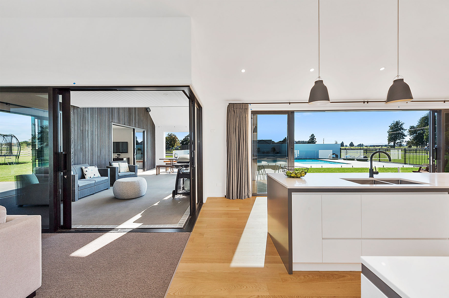 White kitchen interior with a view of the outdoor pool