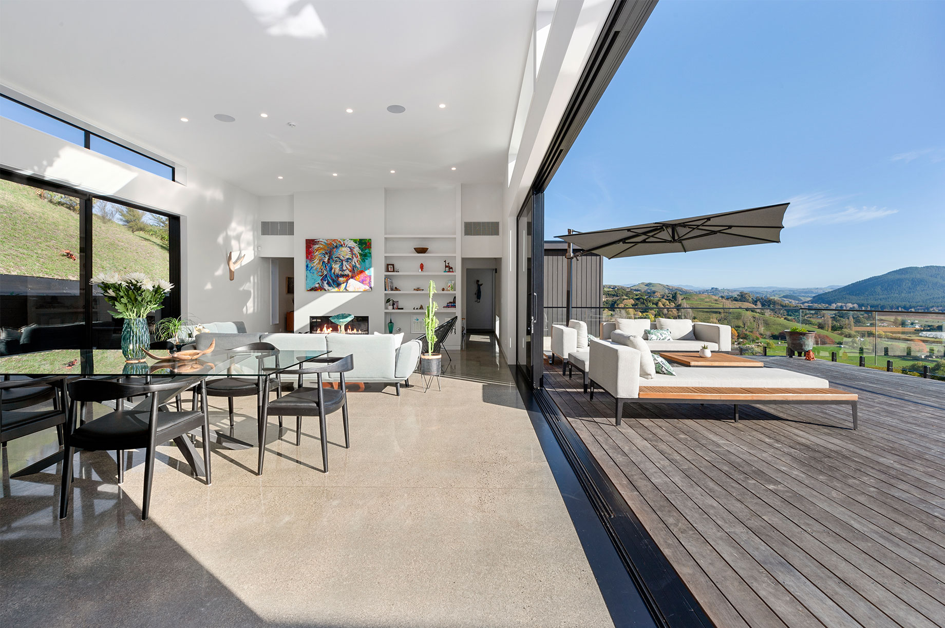 Indoor-outdoor living space with a hill view