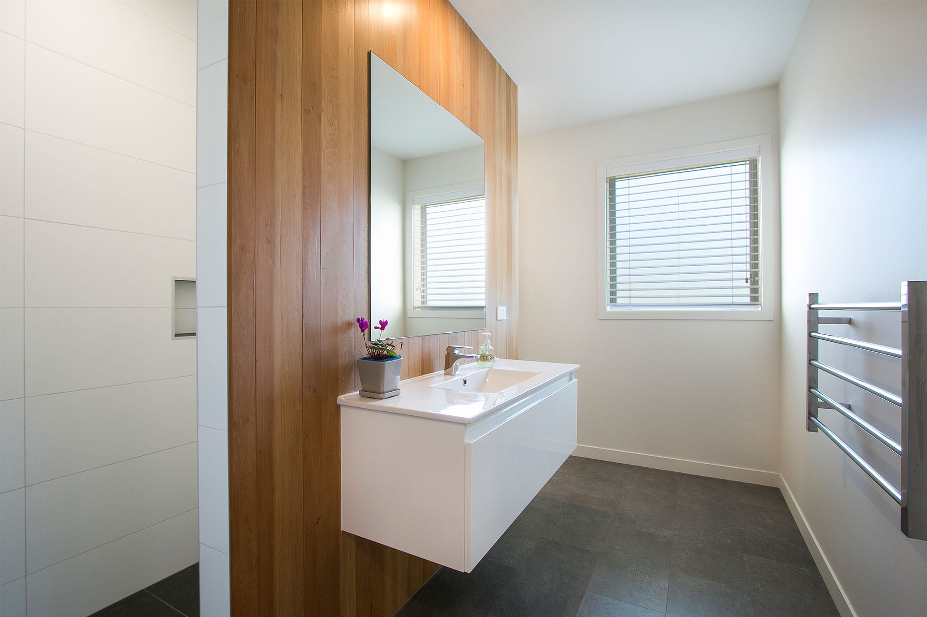 White bathroom with wooden wall