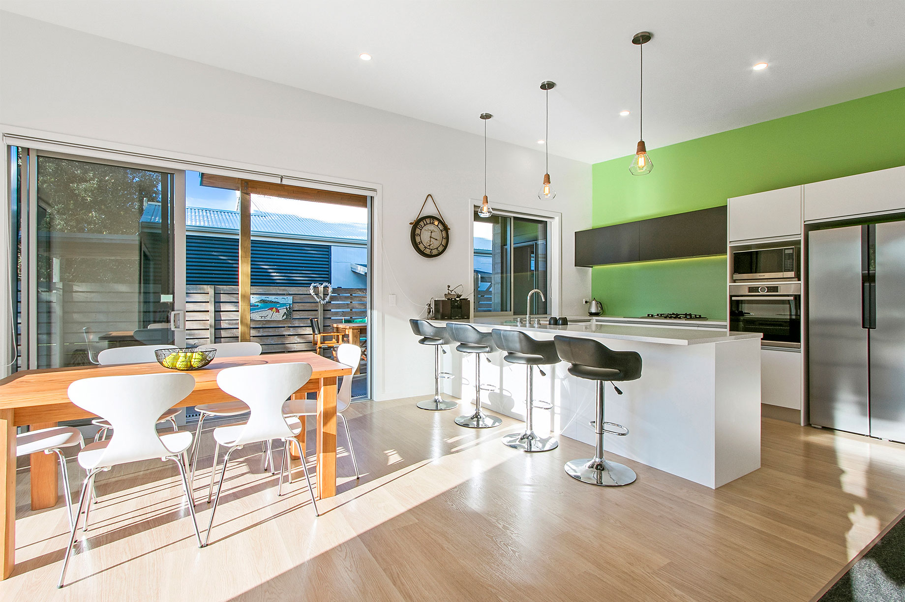 White and black kitchen with a lime green back wall interior