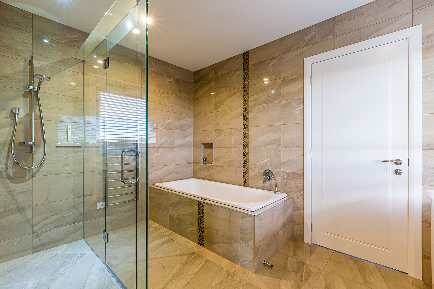 Beige tiled bathroom interior