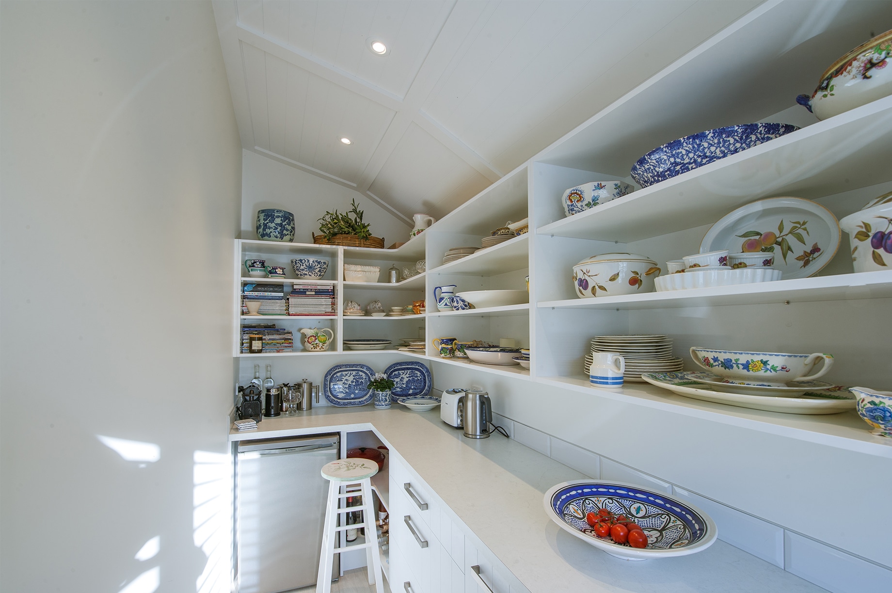 White kitchen pantry with colourful plates