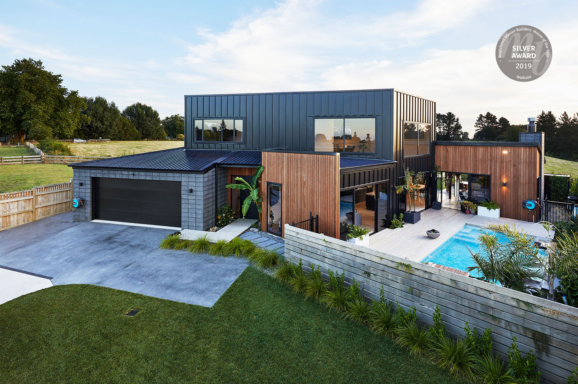 Award winning rural house exterior with a pool