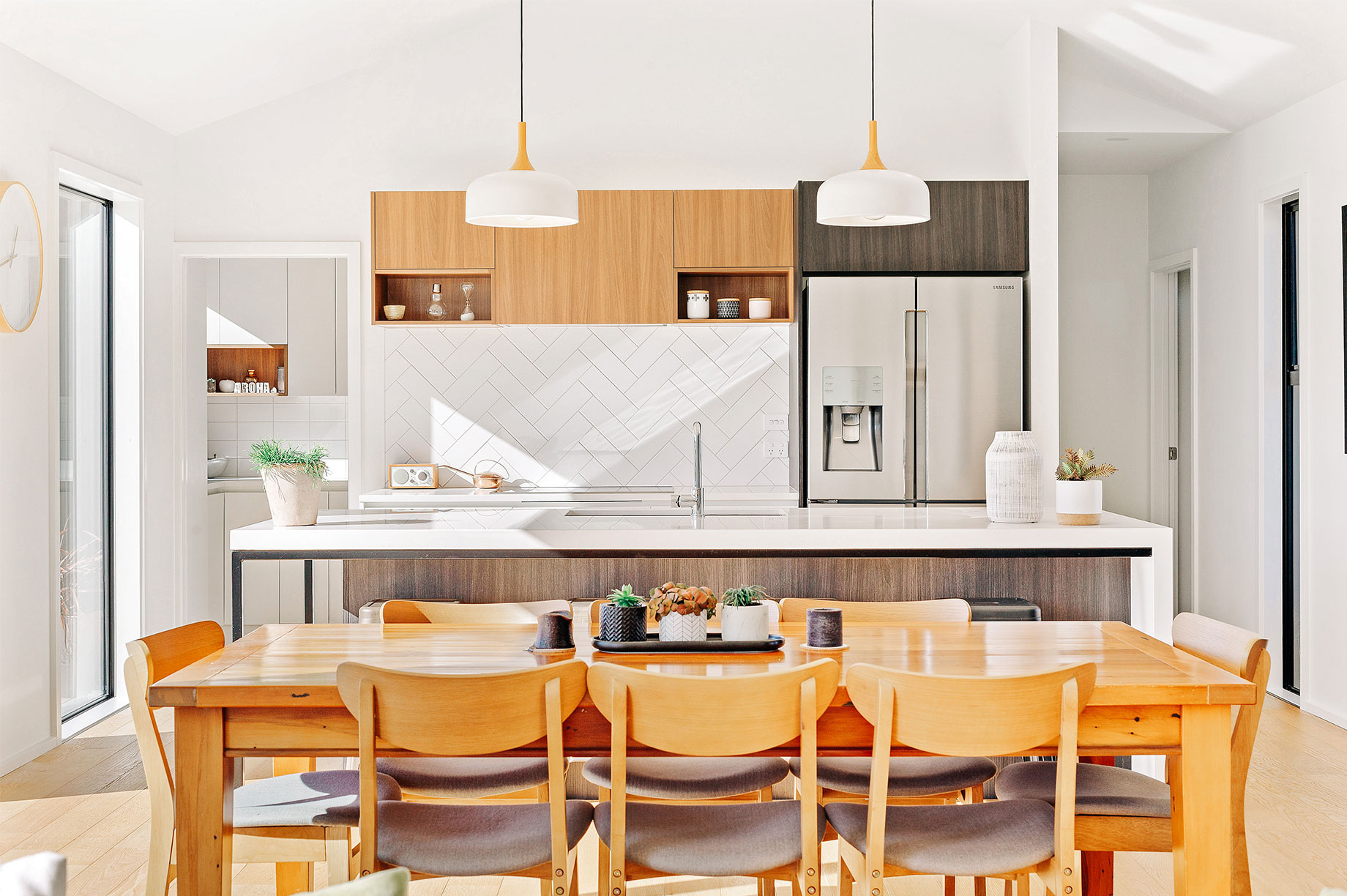 White kitchen with a wooden dining furniture set