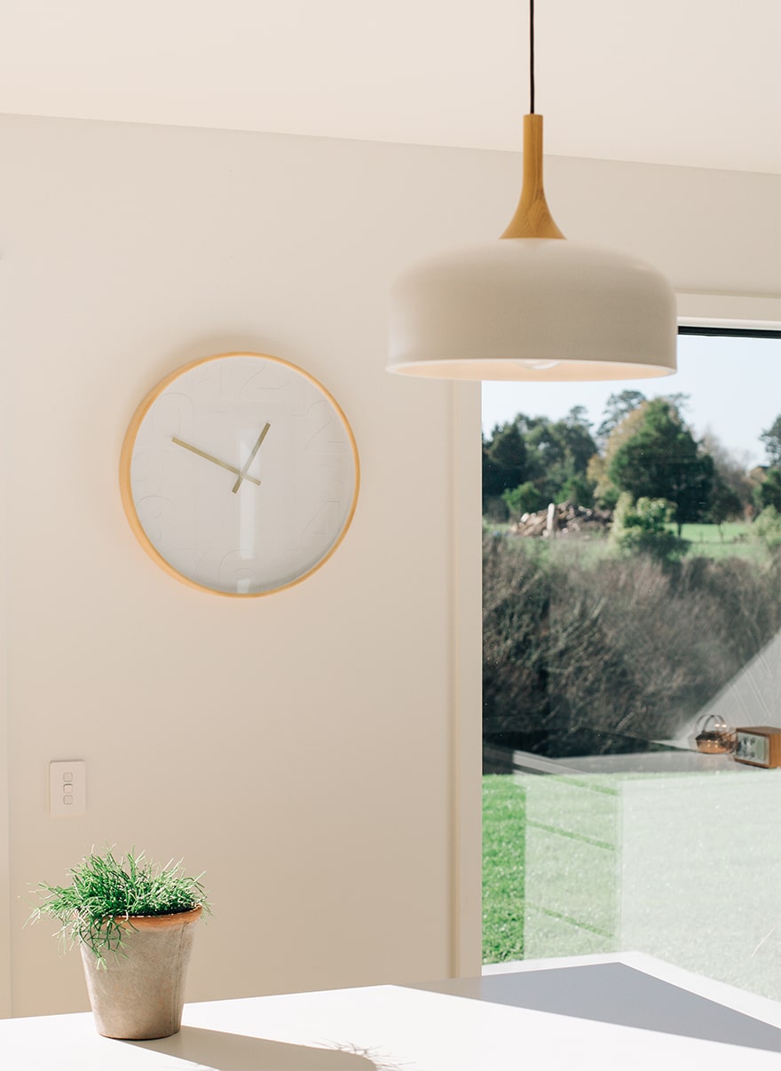 photo of a hanging light and a clock on the wall