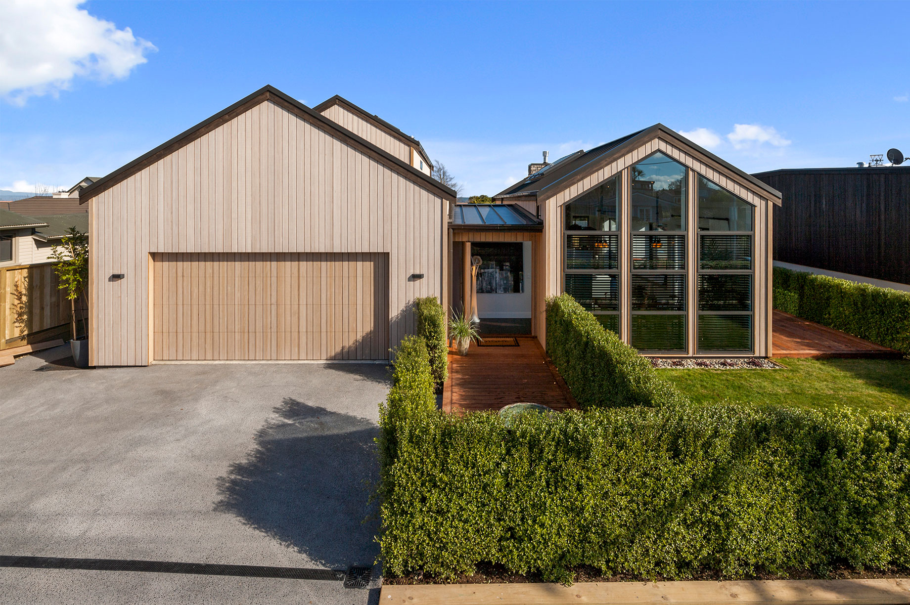 Wooden house with floor to ceiling windows front exterior