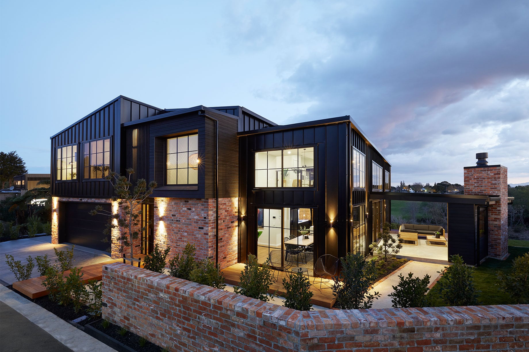 Black and brick home exterior in the evening