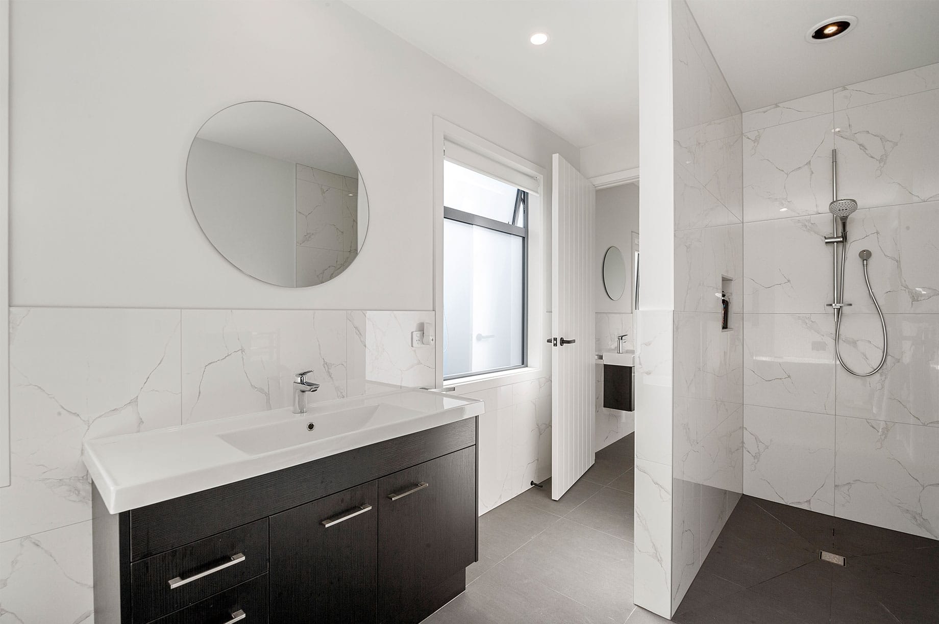 White and black marble tiled bathroom interior