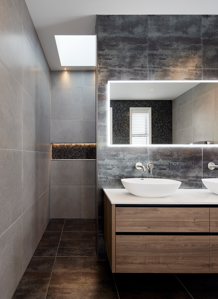 Grey-tiled bathroom with light-up mirror interior