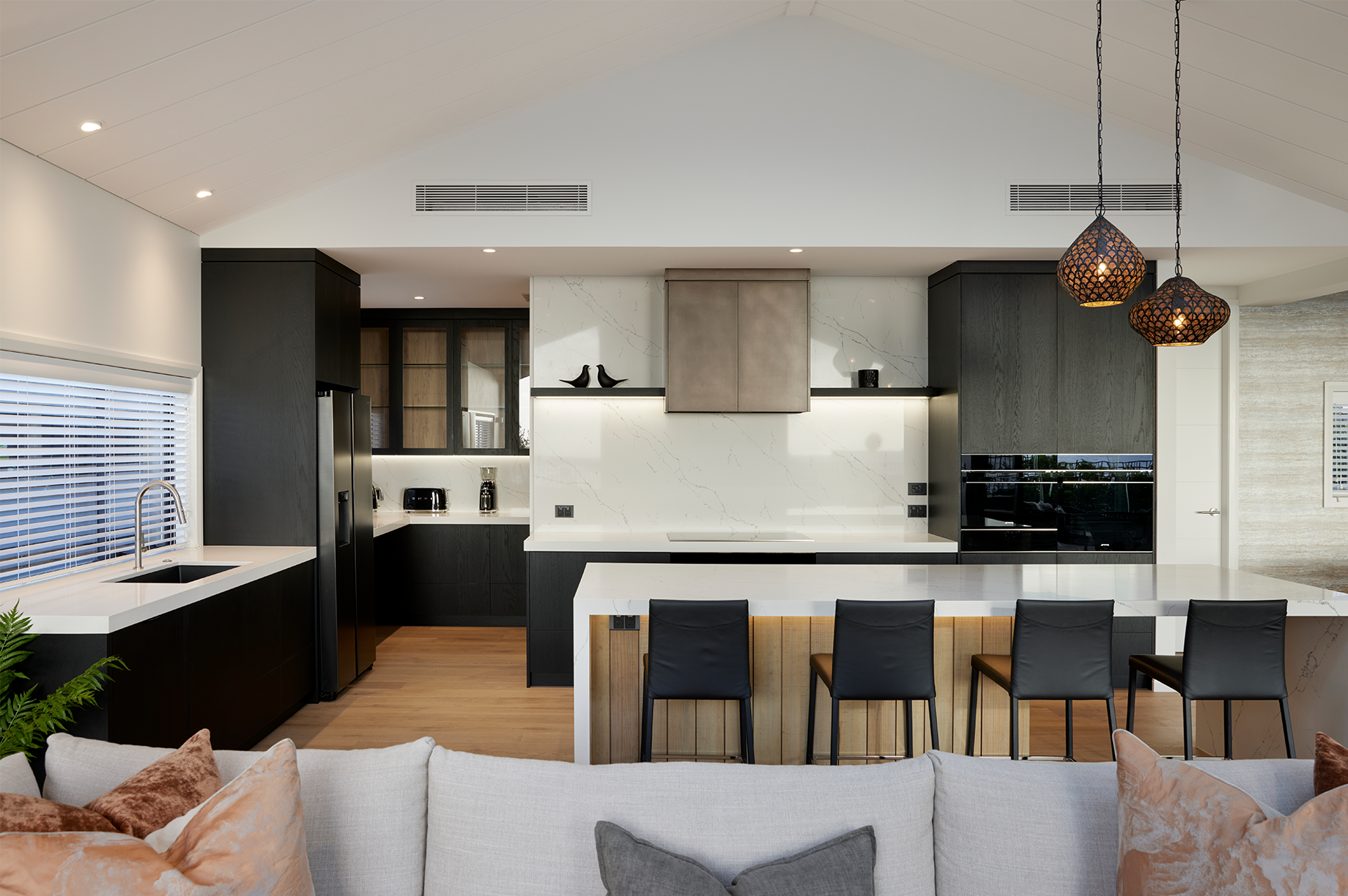 Black kitchen with white bench tops interior