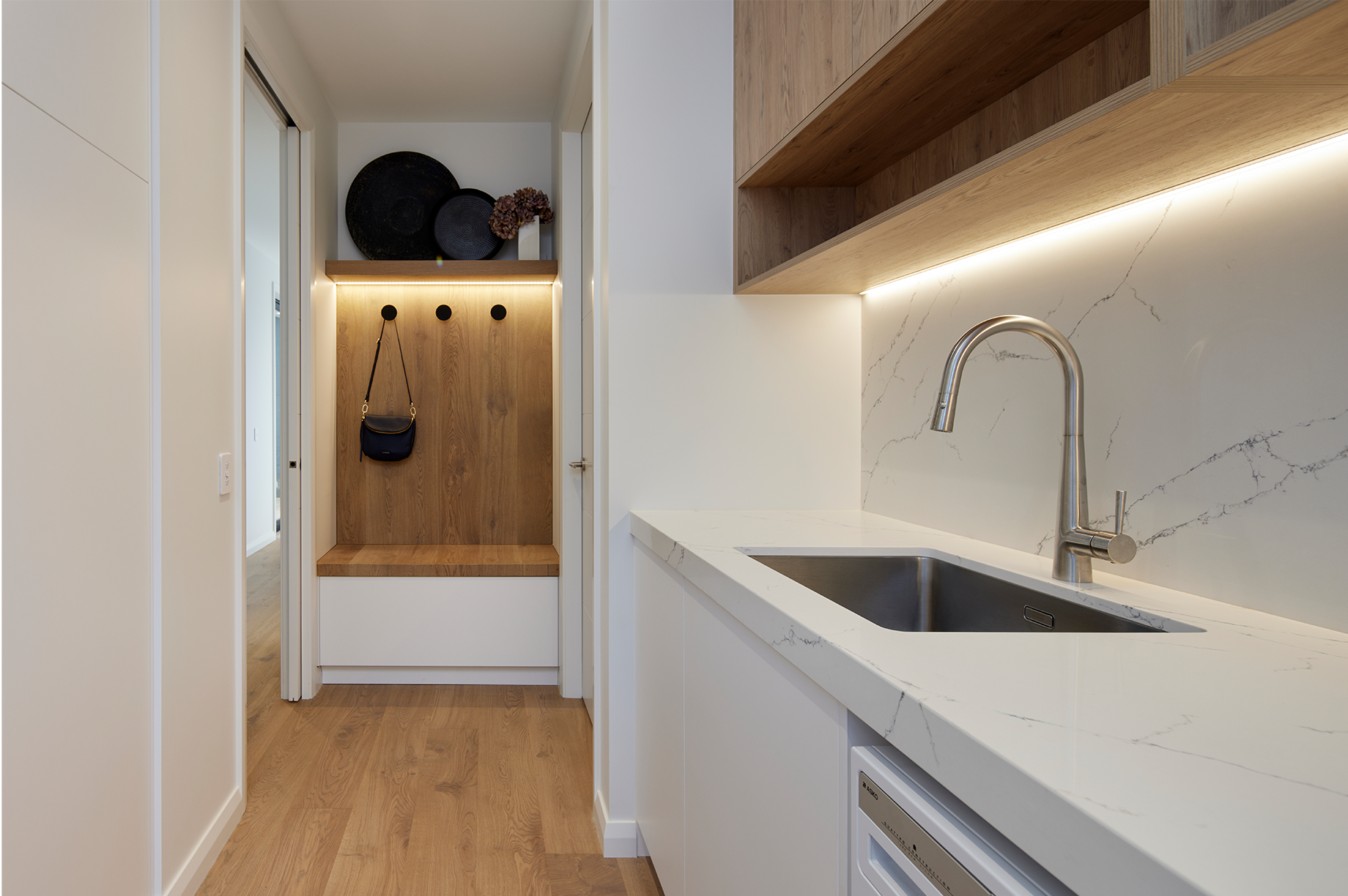 White laundry room interior with built-in cabinet lights
