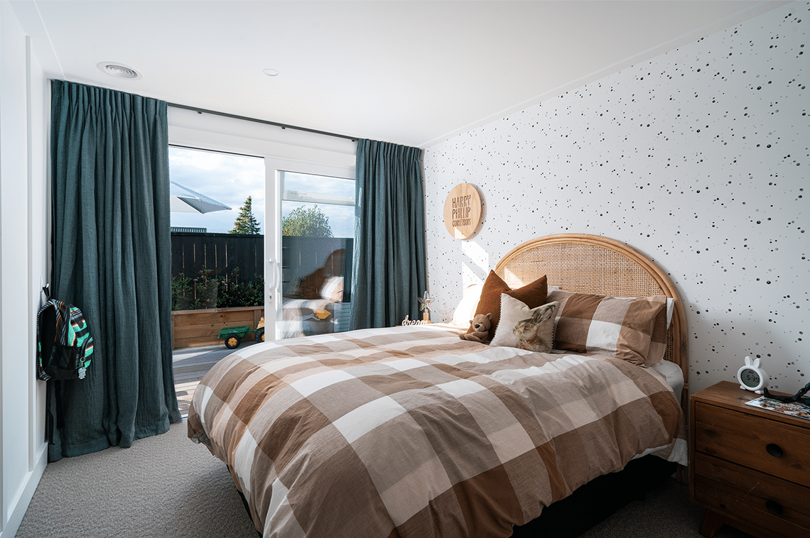 Bedroom with black dotted wallpaper