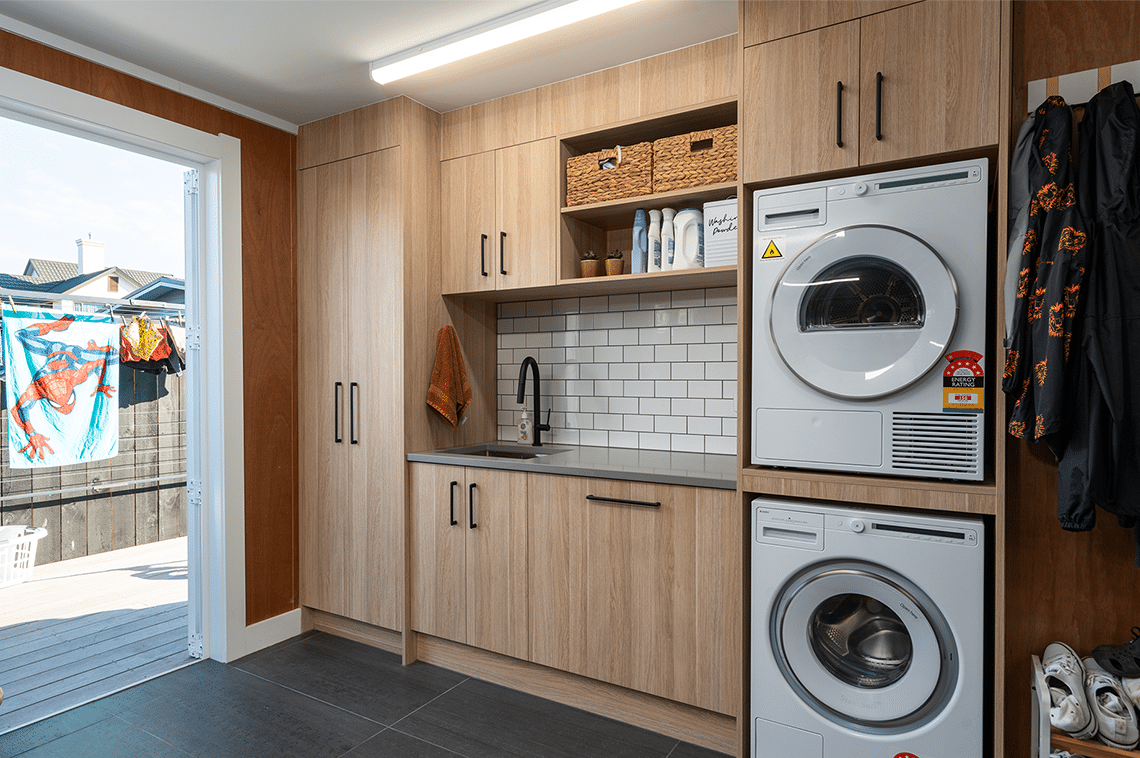 Laundry room with wooden cabinets
