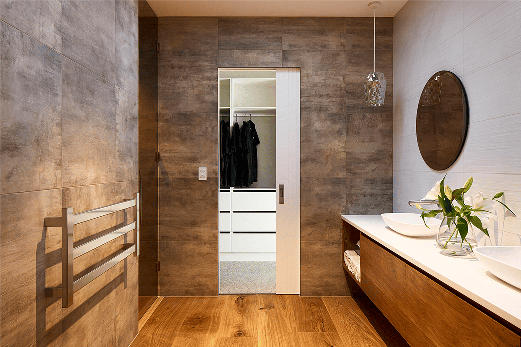 Brown tiled bathroom with wooden floors interior