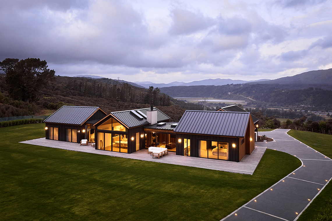 External Design Builders Home, long driveway very lit up