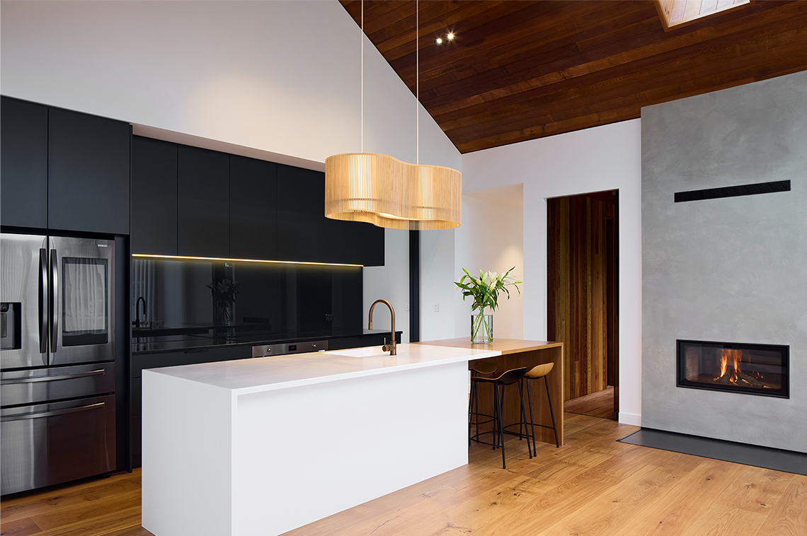Black kitchen interior with a white kitchen island
