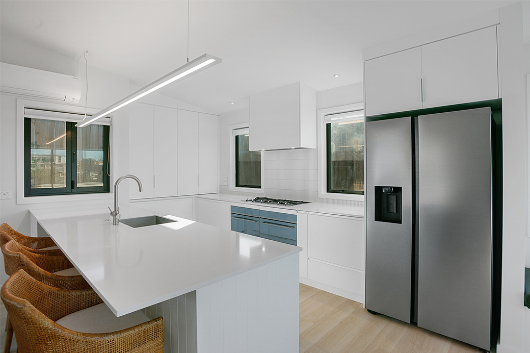 White kitchen interior with a large fridge