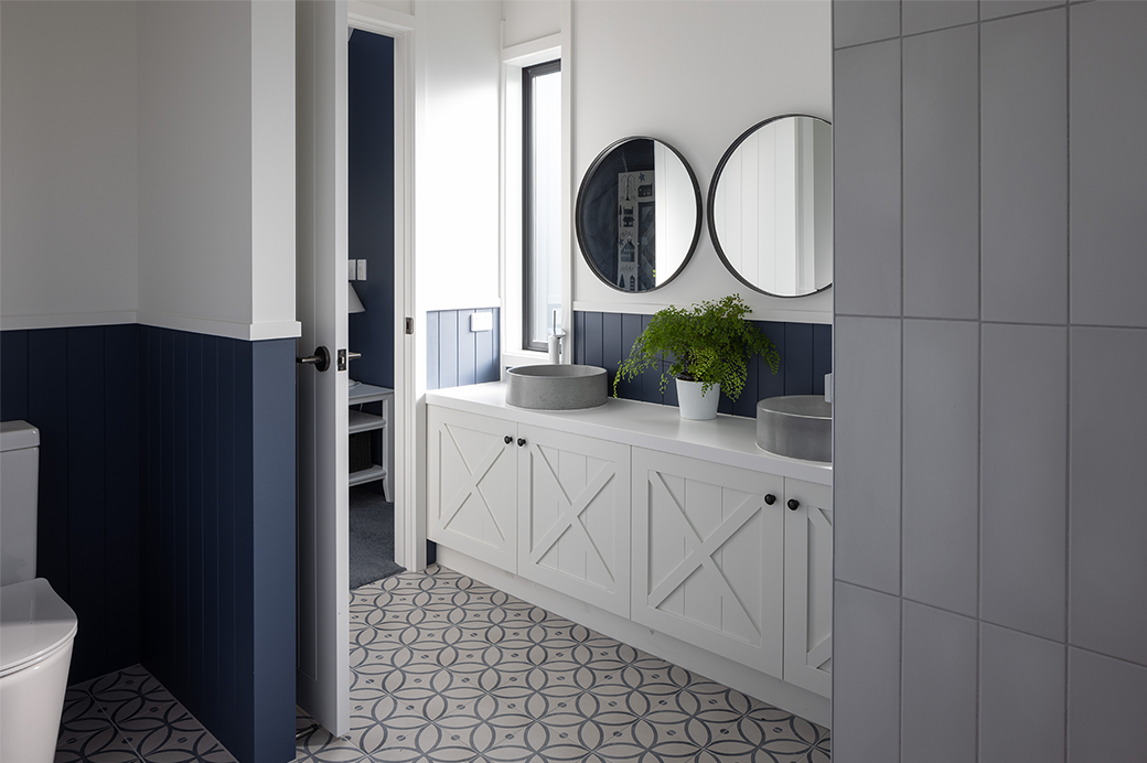 White and blue bathroom with dual sink interior