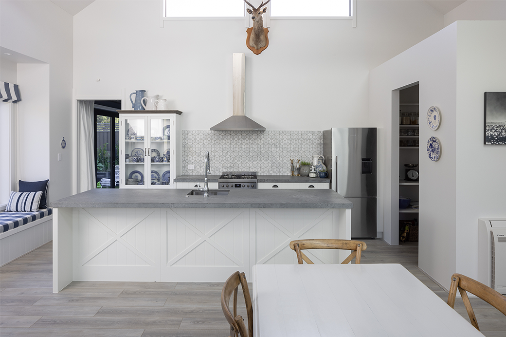 White and grey kitchen and dining area in daylight