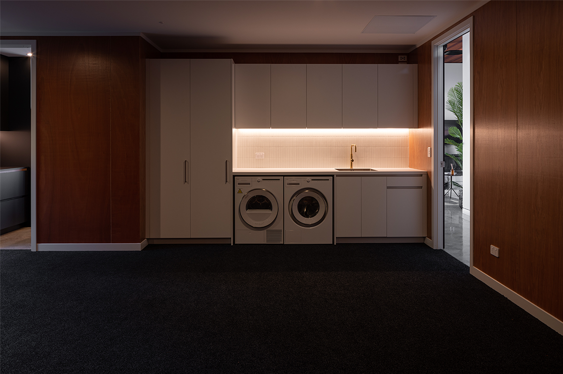 Laundry room with inbuilt cabinet lighting