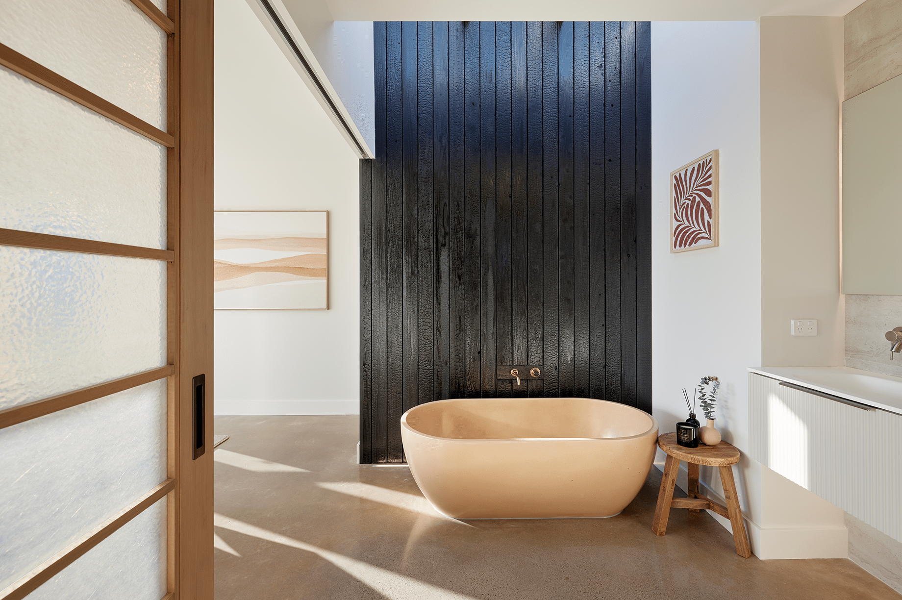 Large bathroom with black wooden panels and a beige bathtub