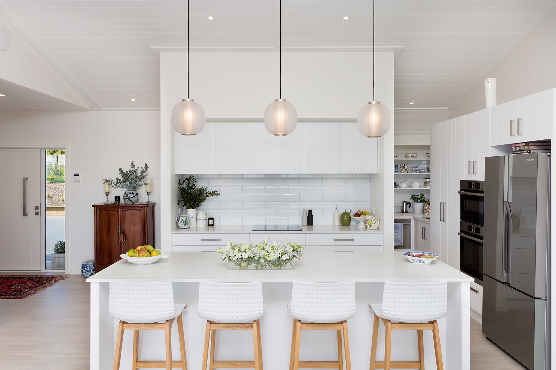 White kitchen interior with hanging decorative lights