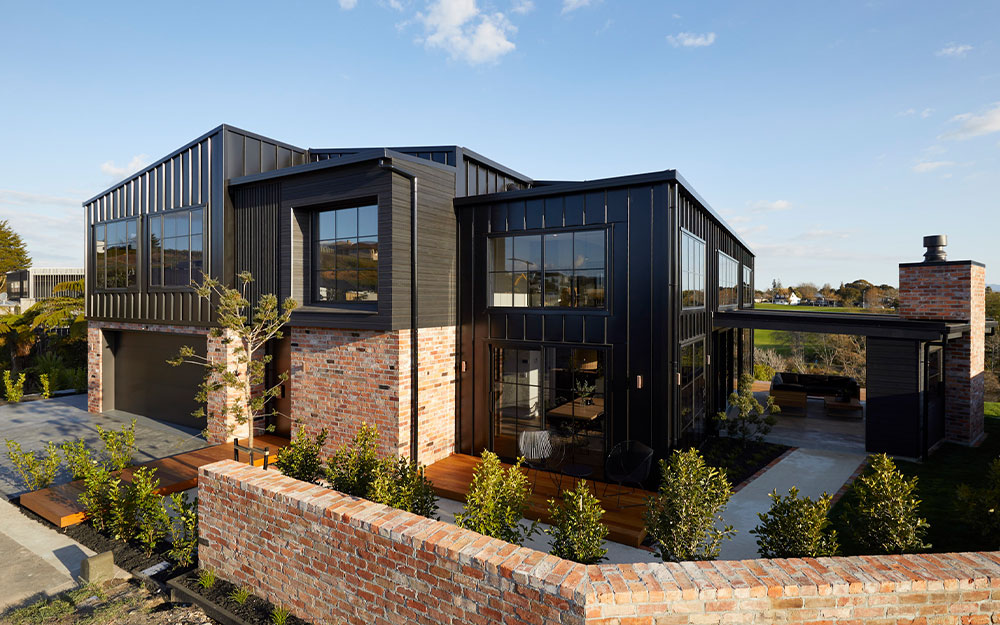 Rural two storey home exterior with brick fencing