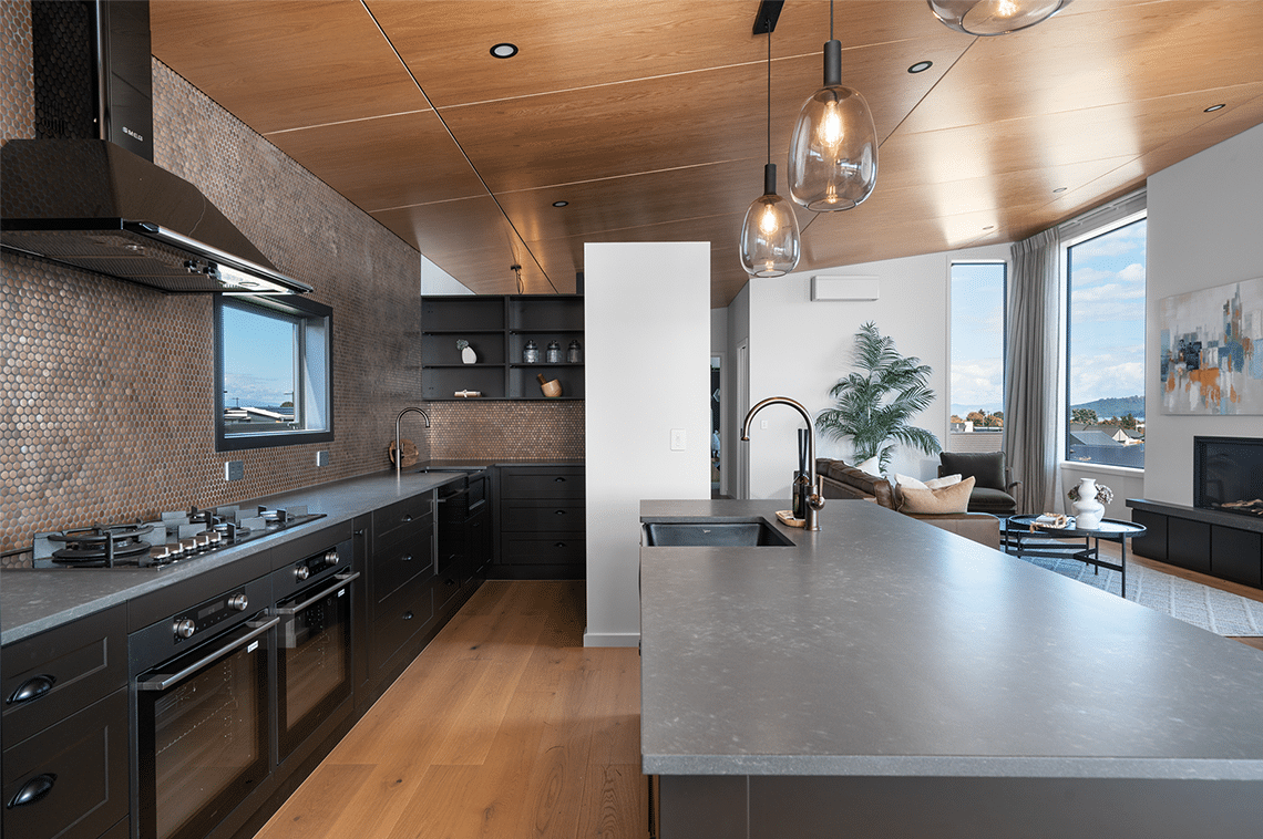 Black kitchen interior with grey bench tops