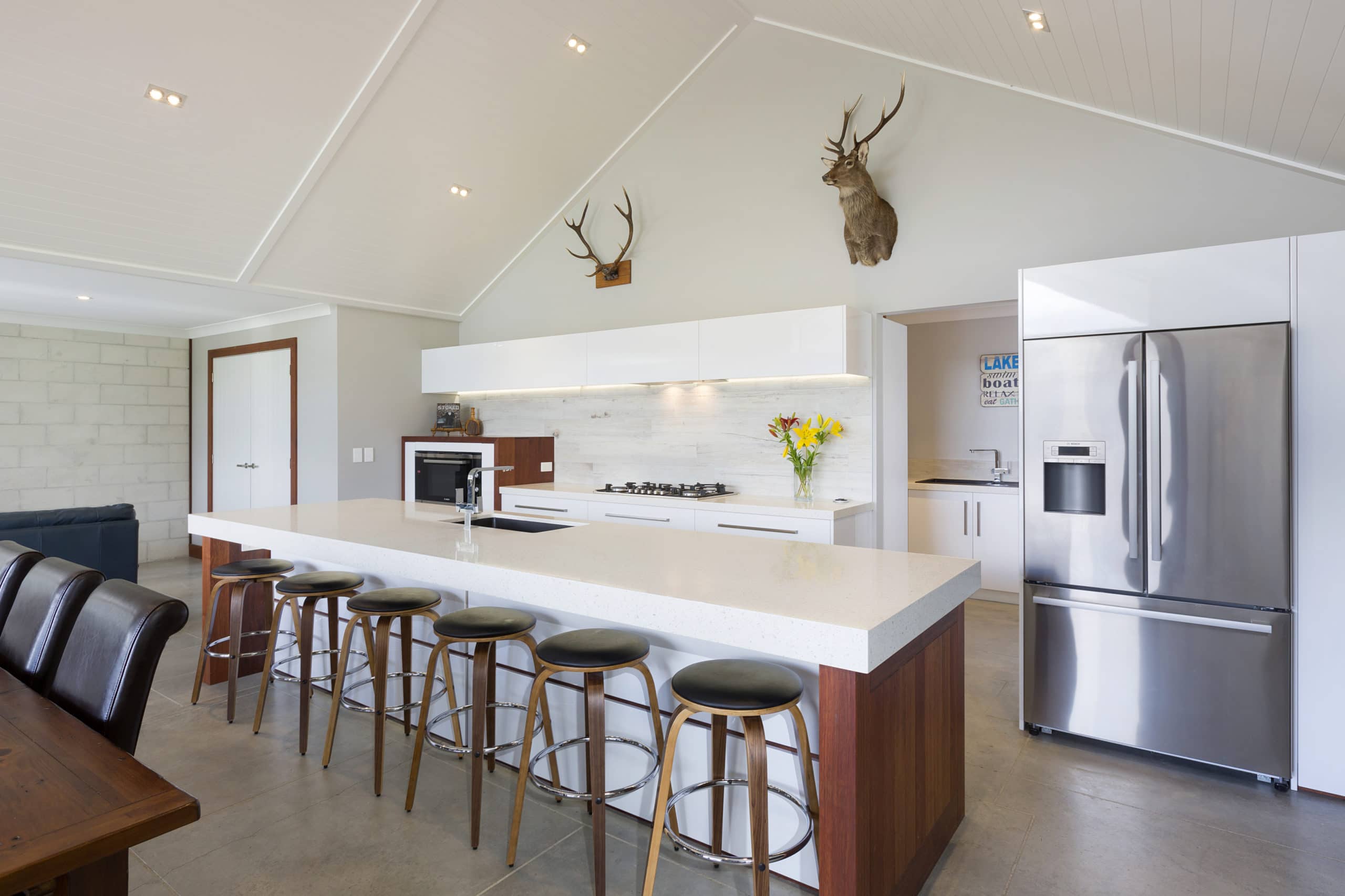 White kitchen with a long kitchen island interior