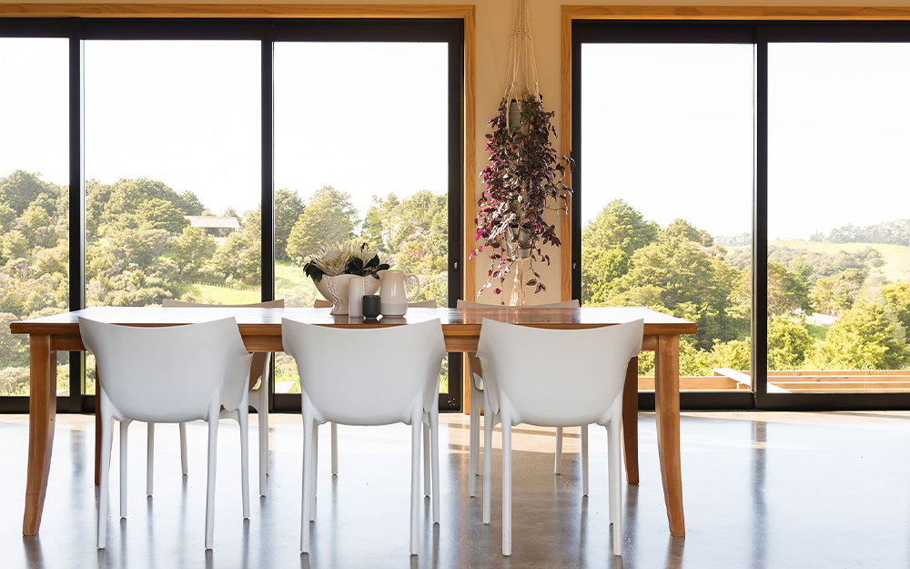 Dining room with a wooden table and white chairs interior