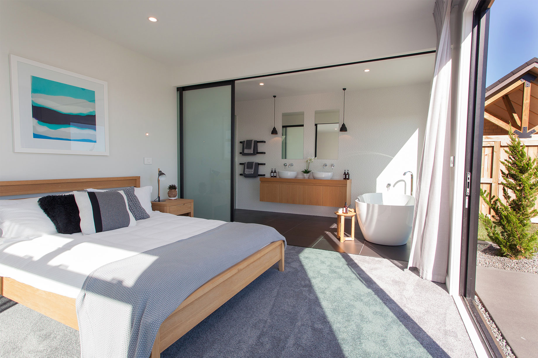 Master bedroom with sliding glass door leading to ensuite