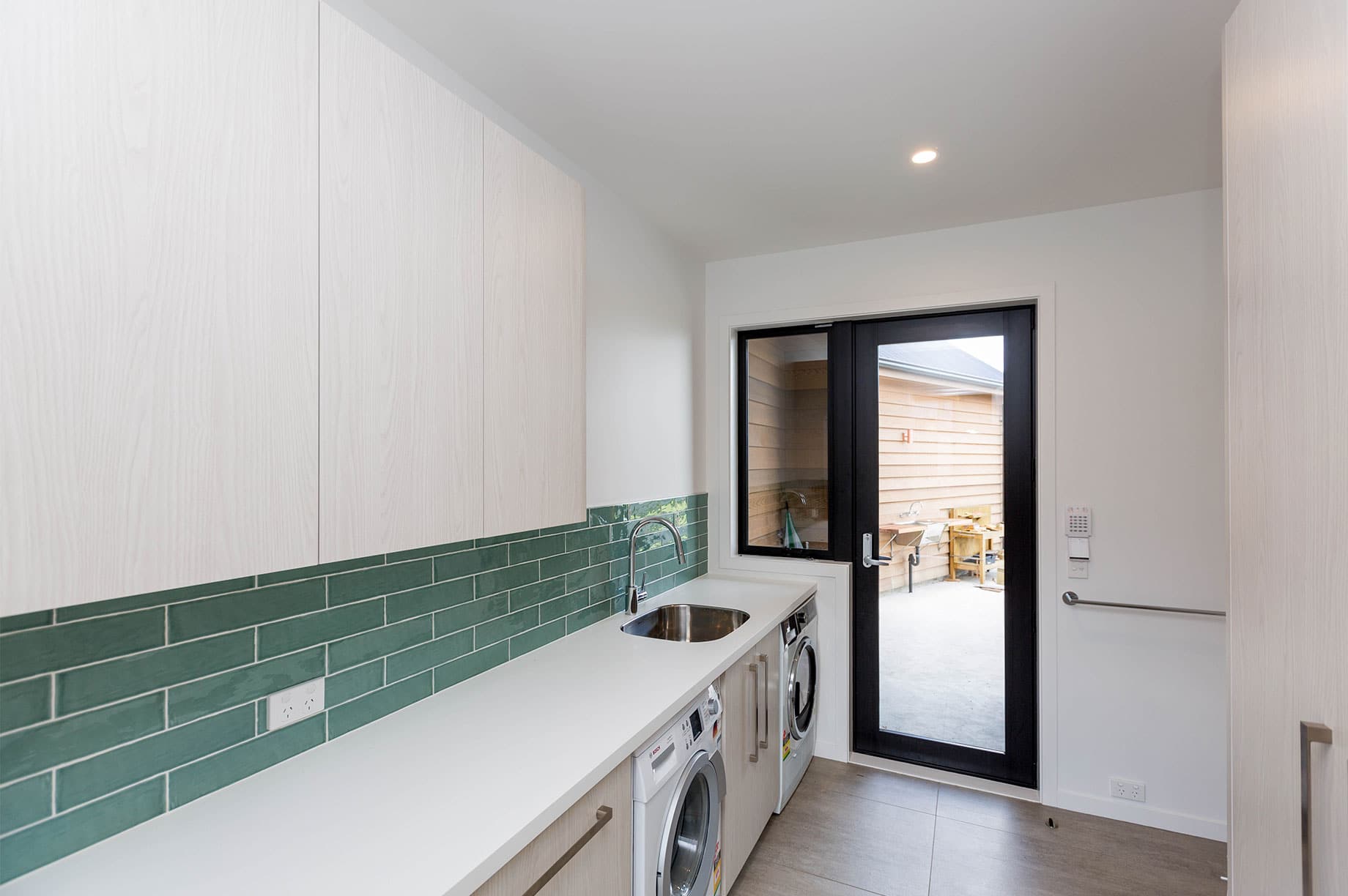 Manawatu home laundry room with teal tiles
