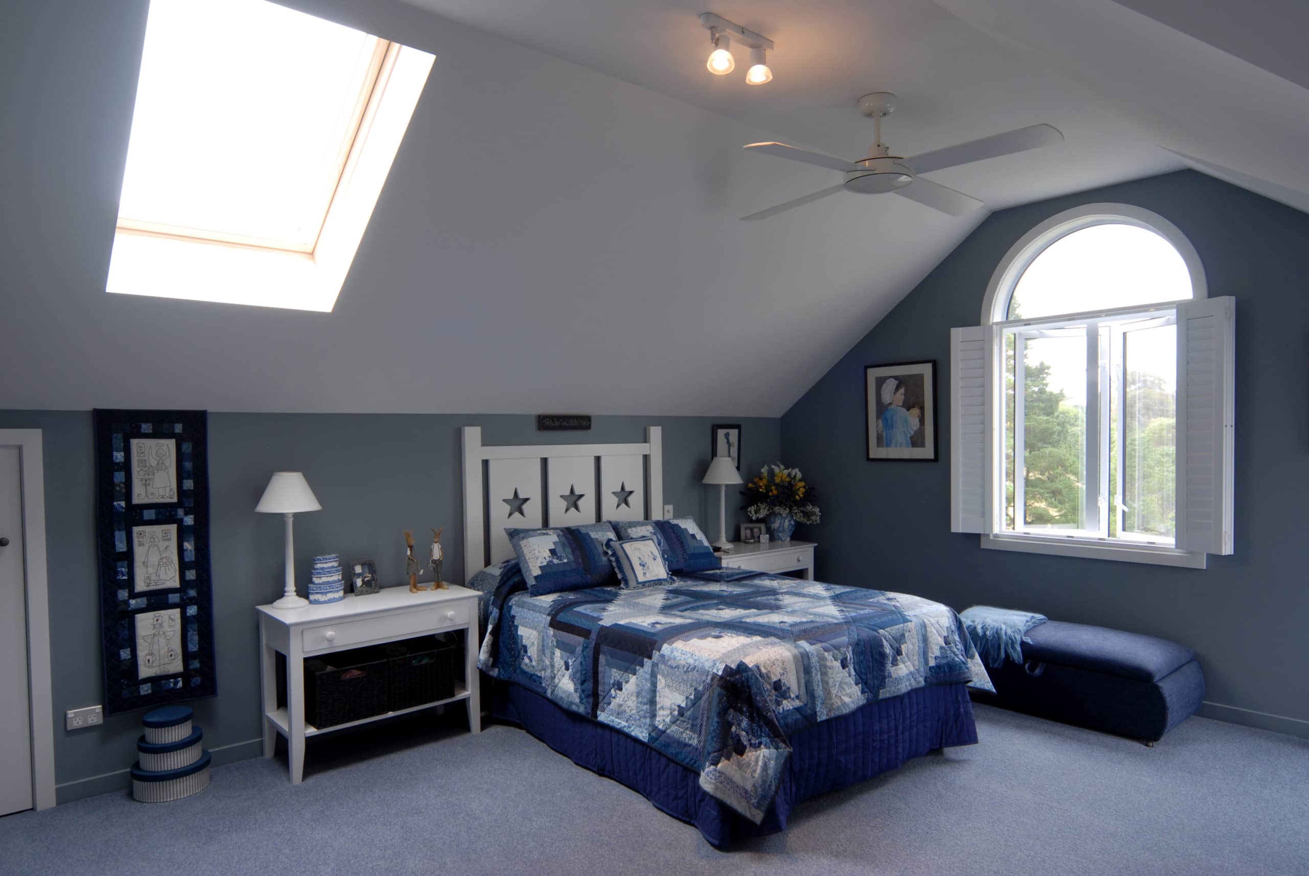 Blue themed bedroom interior with skylight