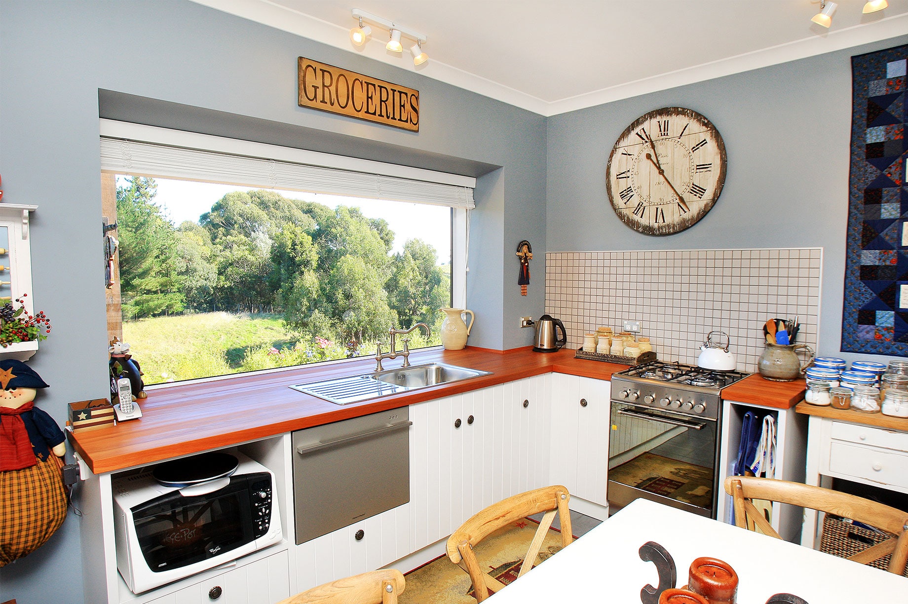 White and wooden kitchen with blue walls interior
