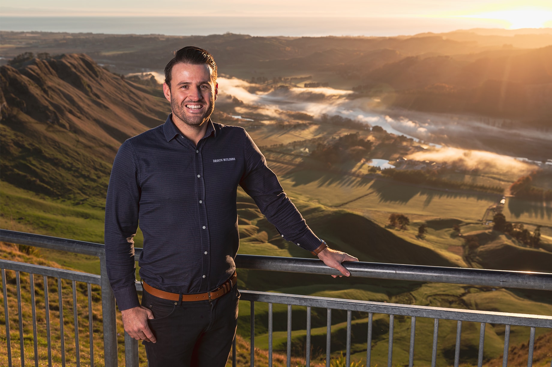 Man in front of scenic hills