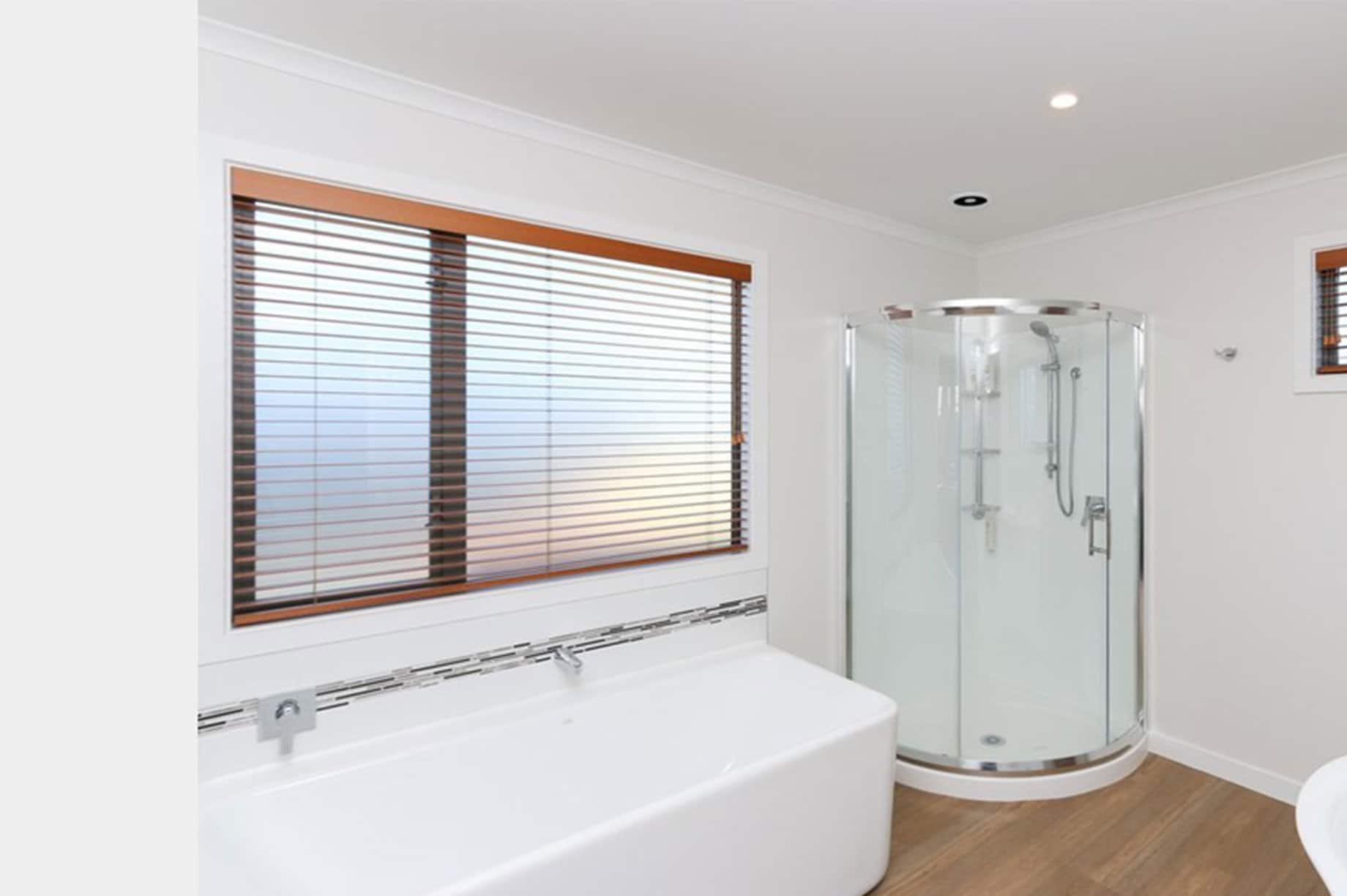 White bathroom with a glass shower cabin interior