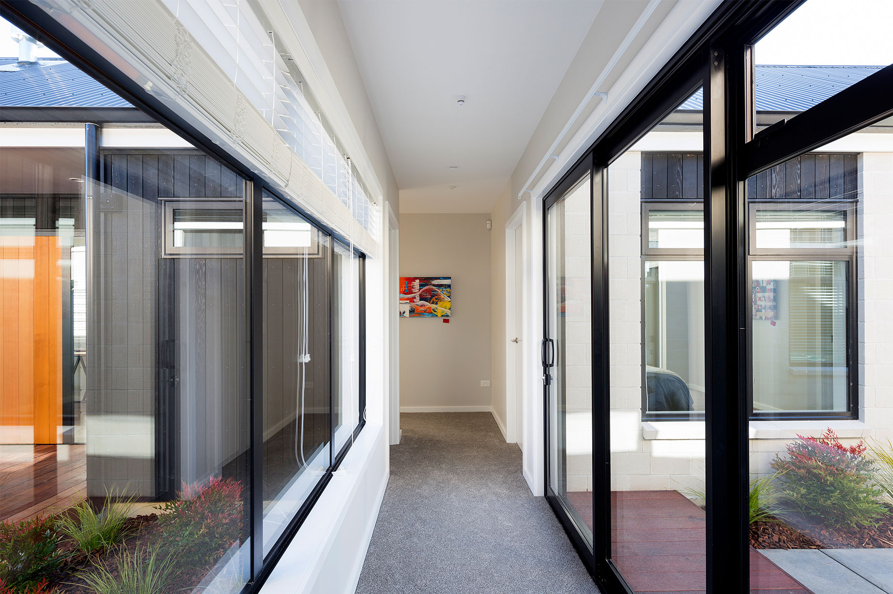 White hallway with sliding glass door